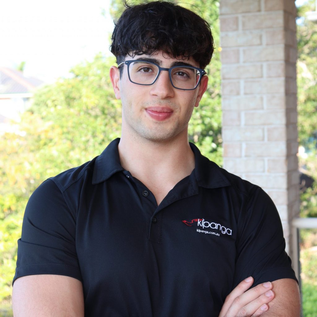 A man with glasses and a black polo shirt stands outside at the Leaders Conference 2025.